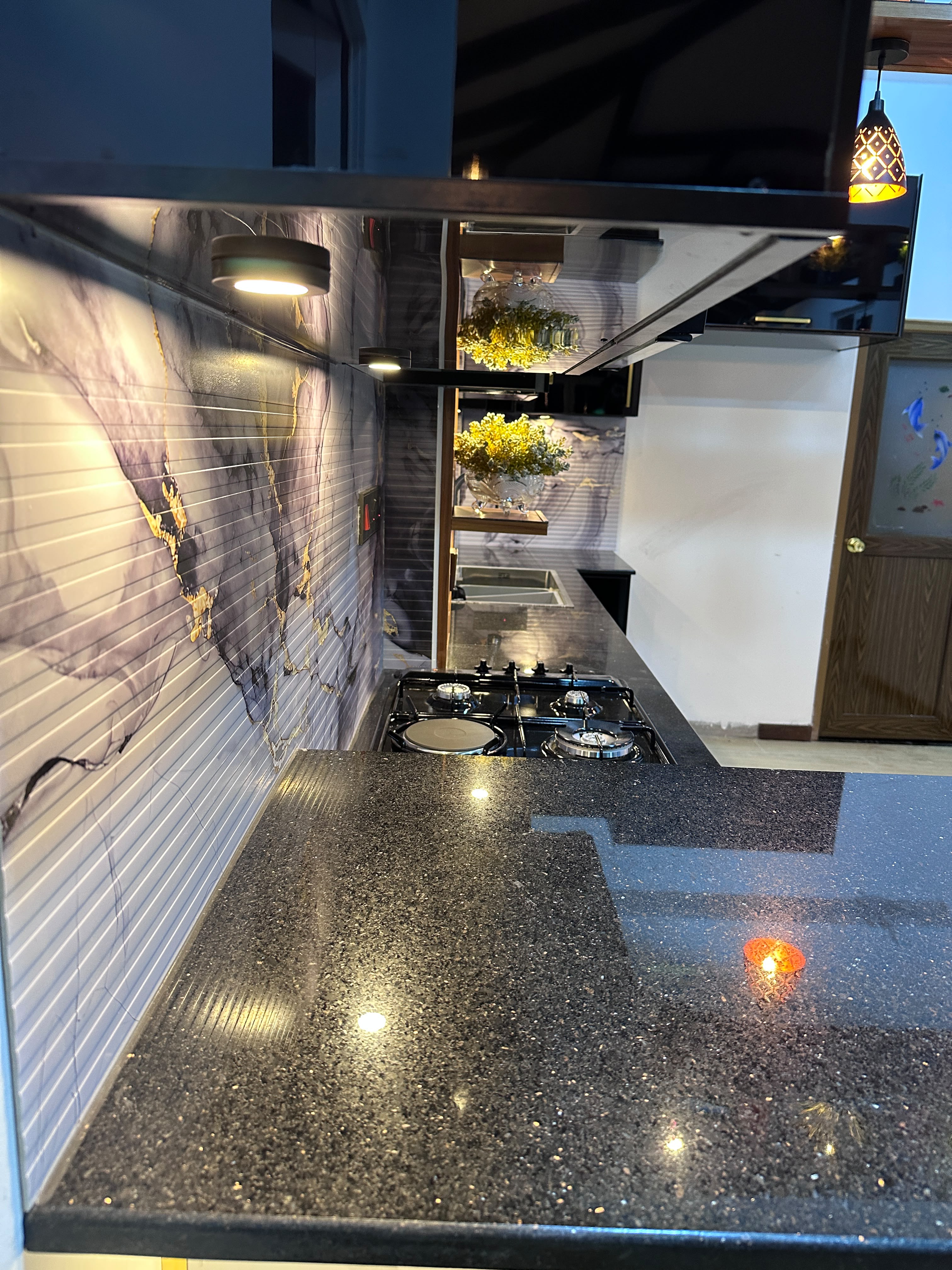 Kitchen countertop with marble backsplash and gas stove
